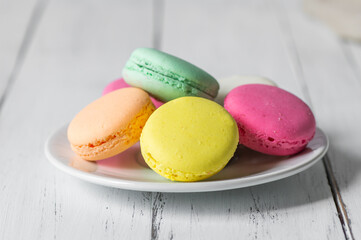 French dessert colorful macarons on rustic background
