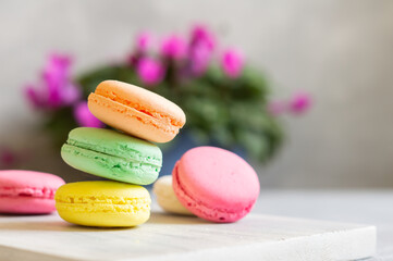 French dessert colorful macarons on rustic background