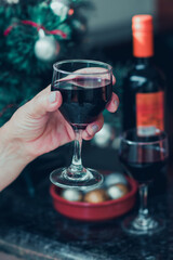 Holding a Wine Glass With Christmas tree at Yard Background