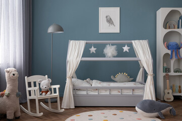 Creative composition of child room interior with mock up poster frame, cozy bed, stylish rack, blue wall, rack with toys, plush lama, gray lamp, guitar and personal accessories. Home decor. Template.	