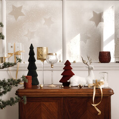 Christmas composition on the vintage shelf in the living room interior with beautiful decoration, big window, christmas tree, candles, stars, gifts, light and elegant accessories. Template.