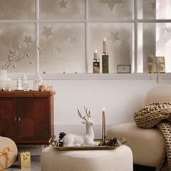 Cozy and stylish christmas living room interior with design armchair, retro shelf, poufm big...