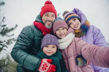 Photo of funky funny little child wife husband dressed coats blogging recording video vlog together outdoors urban forest park