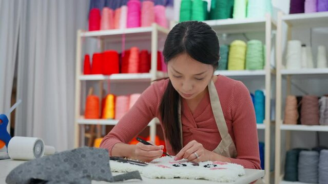 Woman make of tufting carpet at studio