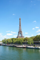 Eiffel tower in Paris during a sunny day .  Travel landmarks in Europe and France .