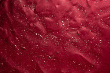 Abstract gel structure with air bubbles on red background, abstract backdrop