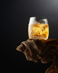 Whiskey with ice in misted glass.