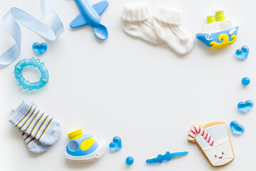 Blue birthday party for baby boy with accessories and gift box, top view