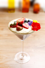 Chocolate mousse dessert, cocktail in a glass, decorated with fresh fruits, selective focus, with blurred background.