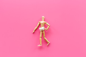 Wooden dummy man with stomach in bandage. Medical insurance and healthcare concept