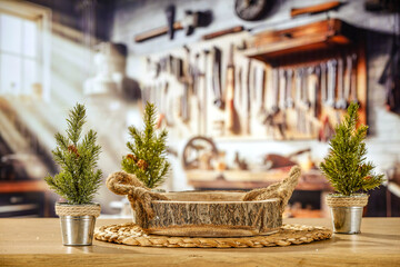 Industrial background of a Christmas workshop. Santa's home and the place where he creates gifts for children. Wooden table and decoration. Blurry background of metal tools and machines for work. 