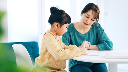 女の子に勉強を教える女性