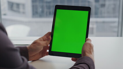 Man hands holding tablet chromakey city view table. Student reading mockup pad