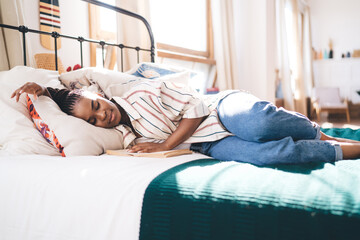 Young black woman sleeping on bed