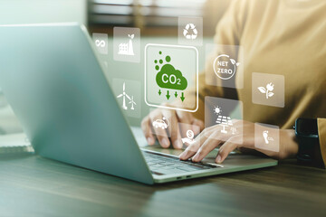 Company use computer report results to reduce CO2 emissions carbon footprint climate change and Net zero to limit global warming. Sustainable development and innovation green business concept. - obrazy, fototapety, plakaty