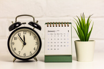 Hello January. On the table is a calendar for January 2024.