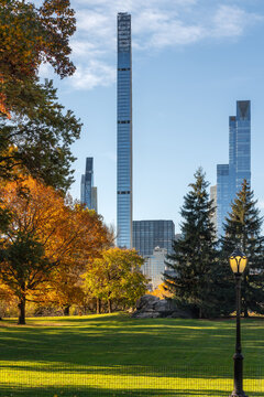 Fall foliage in Central Park with Billionaires Row supertall skyscrapers. Midtown Manhattan, New York City