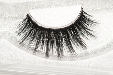 Black long false eyelashes close-up on white background. Self-adhesive eyelashes, eyelash...