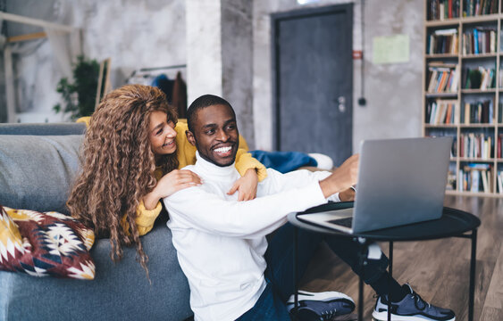 Young Adult Interracial Couple Enjoying Leisure Time At Home