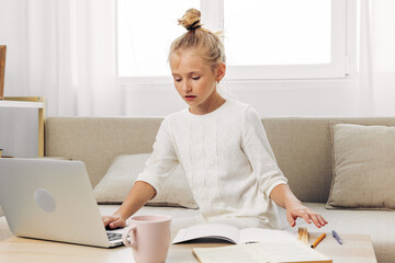 Learning child online education homework schoolgirl distance couch laptop school