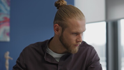 Serious man working office portrait. Focused guy writing notes learning closeup