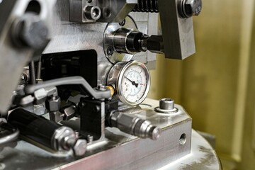 Fototapeta na wymiar The pressure gauge on the hydraulic clip with a mechanical switch.