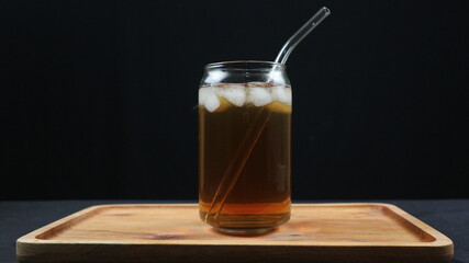 Glass of tasty Long Island iced tea on dark background with space for text