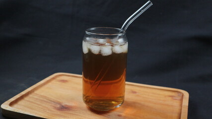 Glass of tasty Long Island iced tea on dark background with space for text