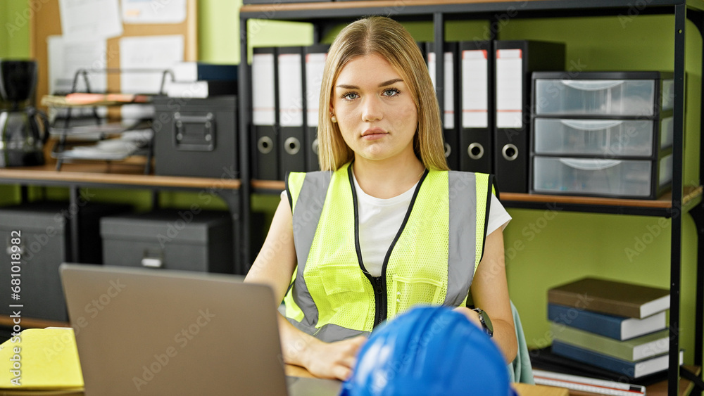 Wall mural Young blonde woman architect using laptop working at office