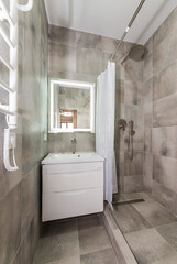 Tiled bathroom interior, sink and mirror