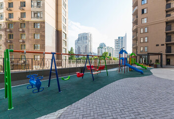 Children's playground in the courtyard of a modern high-rise residential complex, an example of modern architecture
