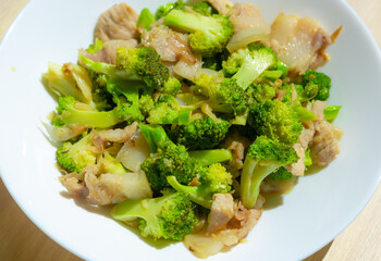 Stir-fried vegetables with pork , Broccoli stir with Thai food style in the white plate.