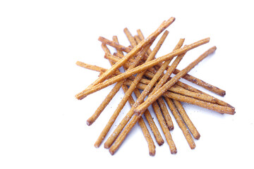 Crunchy salty and spicy flavored pretzel sticks, breadsticks, snacks on white background. Concept, junk food, appetizer.     