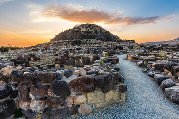 The bronze age fort UNESCO world heritage site Su Nuraxi di Barumini on Sardinia island during sunset.  - obrazy, fototapety, plakaty