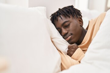 African american man lying on bed sleeping at bedroom