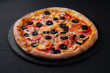 Pizza with tomato, olives, champignons, ham and cheese