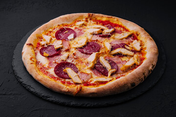 Pepperoni Pizza with Basil and Parmesan Cheese on Black Stone Plate