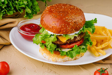 cheeseburger with french fries and ketchup on plate