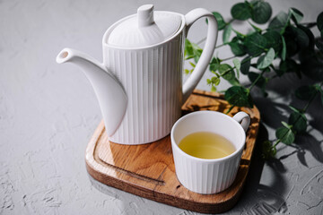 Japanese green tea in white cup and teapot