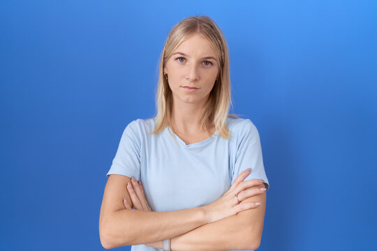 Young caucasian woman wearing casual blue t shirt skeptic and nervous, disapproving expression on face with crossed arms. negative person.