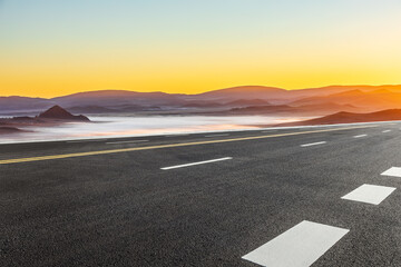 Asphalt highway road and mountain natural landscape at sunrise