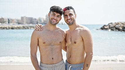 Two men tourist couple smiling confident hugging each other at beach