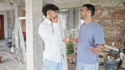 Fototapeta premium Two men couple speaking at construction site