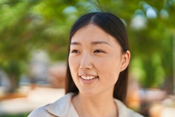 Chinese woman smiling confident looking to the side at park