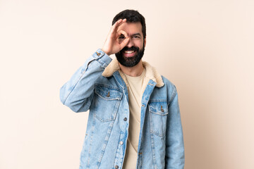 Fototapeta premium Caucasian man with beard over isolated background showing ok sign with fingers