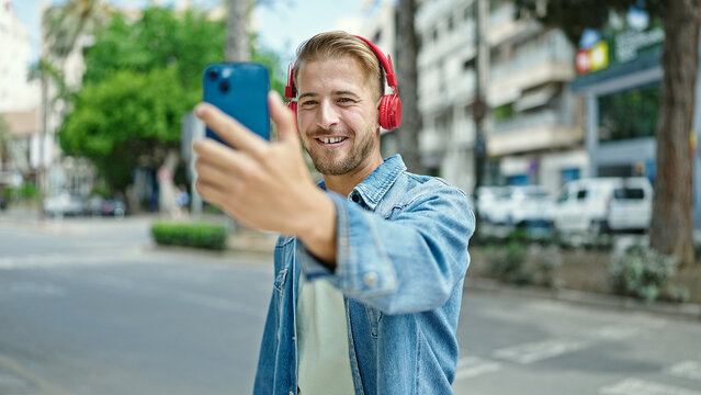 Young caucasian man smiling confident having video call at street