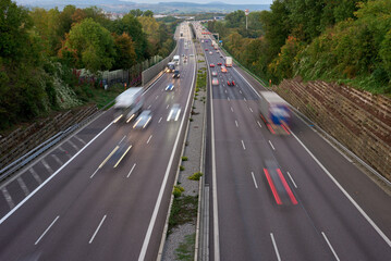 Long exposure photo of traffic with blurred traces from cars, top view. road, cars, blurred traffic, evening, top view. Highway at evening, blue hour illuminated by the traffic of cars