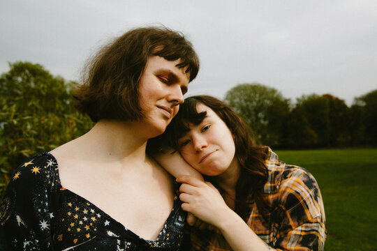 Portrait of two young adults in trendy outfits at the park