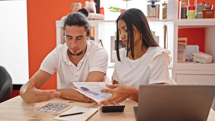 Man and woman couple using laptop accounting at dinning room