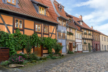 Street with historic half-timbered houses in the historic old town of Quedlinburg
